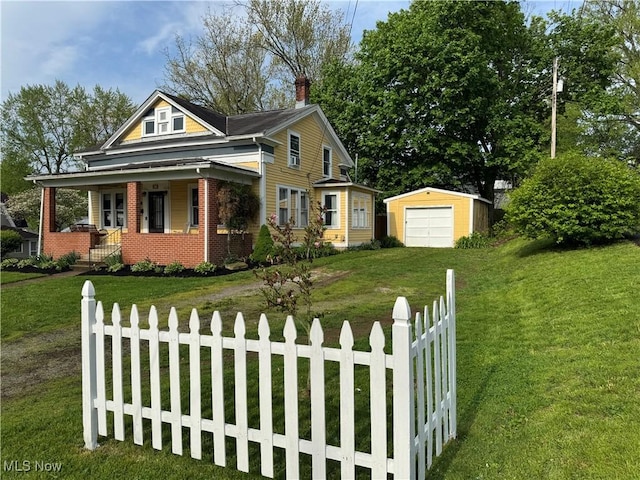 view of front facade featuring covered porch, a chimney, an outbuilding, fence private yard, and a front lawn