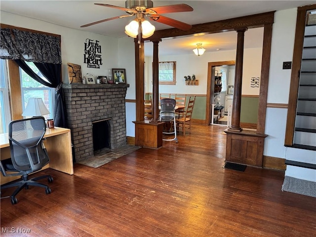 living room featuring ceiling fan, a wealth of natural light, and wood finished floors