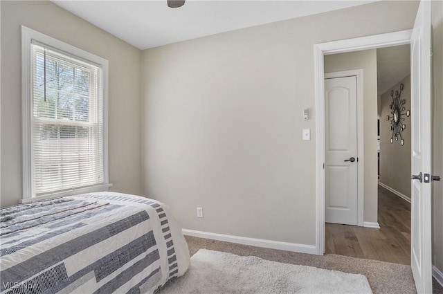 carpeted bedroom featuring baseboards
