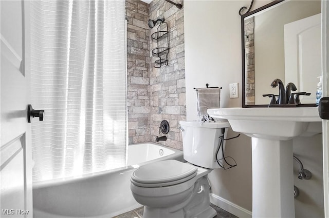 bathroom featuring baseboards, toilet, and shower / bathtub combination with curtain