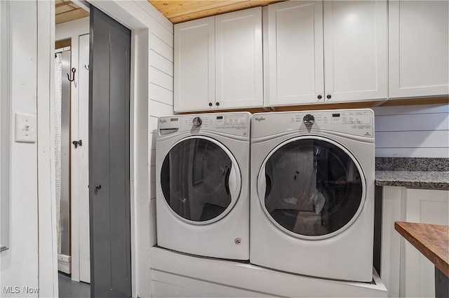 washroom featuring washing machine and clothes dryer and cabinet space