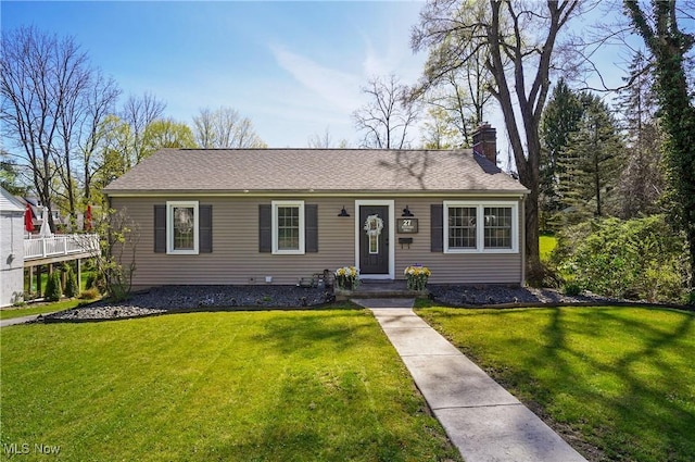 single story home with a chimney and a front lawn