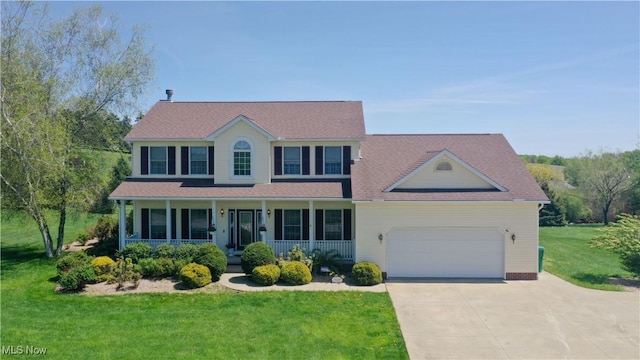 16544 Davis Dr, Calcutta, OH 43920 - view of front of home featuring a porch, concrete driveway, a front yard, and a garage