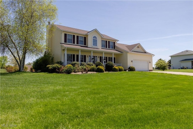 16544 Davis Dr, Calcutta, OH 43920 - view of front of property featuring an attached garage, a front lawn, driveway, and a porch