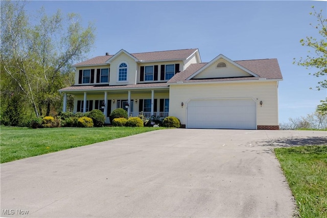 16544 Davis Dr, Calcutta, OH 43920 - colonial house with a garage, concrete driveway, a porch, and a front lawn