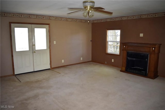 240 S 15th St, Sebring, OH 44672 - unfurnished living room featuring ceiling fan, a fireplace, carpet floors, french doors, and baseboards