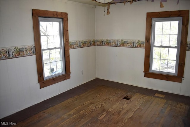 240 S 15th St, Sebring, OH 44672 - empty room with wainscoting, visible vents, and dark wood-style floors