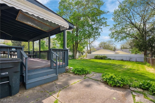 view of patio / terrace featuring fence and a deck
