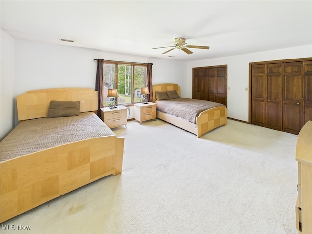 155 Richwood Ct, Belpre, OH 45714 - bedroom with two closets, ceiling fan, visible vents, and light carpet