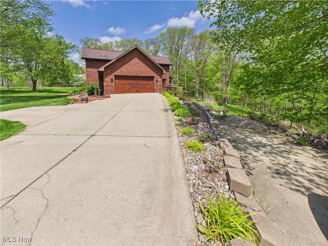 155 Richwood Ct, Belpre, OH 45714 - view of front of house featuring brick siding, a garage, and driveway