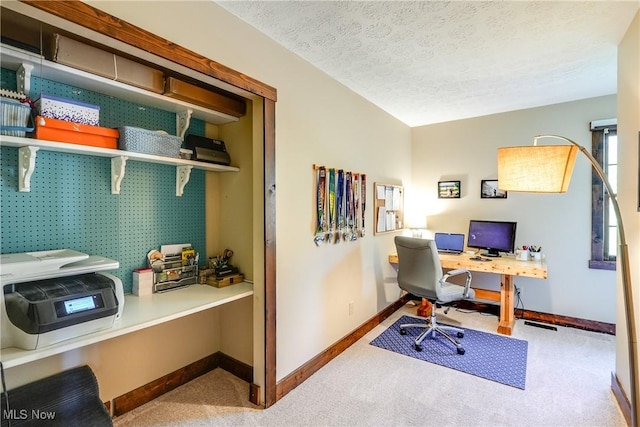 office with carpet flooring, a textured ceiling, baseboards, and visible vents