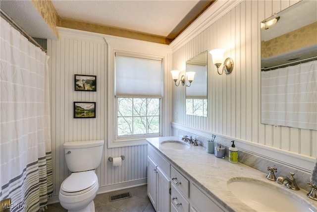 bathroom featuring visible vents, a sink, tile patterned flooring, and toilet
