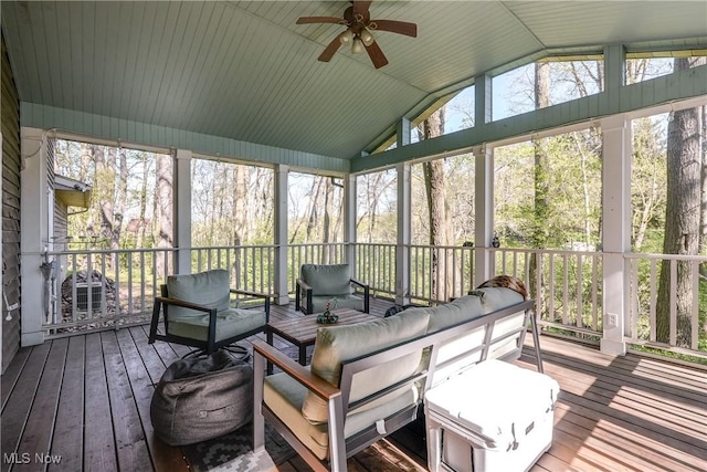 sunroom with ceiling fan, an outdoor living space, and a wealth of natural light