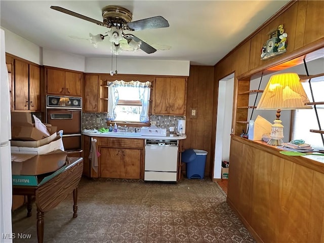 kitchen with white dishwasher, open shelves, a ceiling fan, and brown cabinets