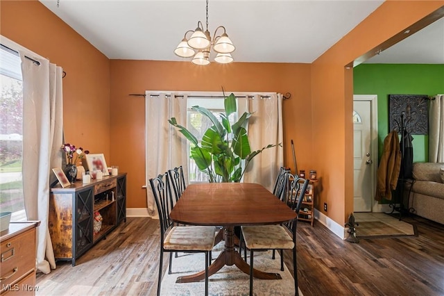 294 Jennings Ave, Salem, OH 44460 - dining area with baseboards, a notable chandelier, and wood finished floors