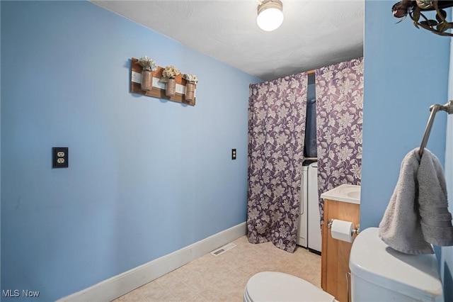 294 Jennings Ave, Salem, OH 44460 - full bath featuring visible vents, vanity, washer / dryer, toilet, and baseboards
