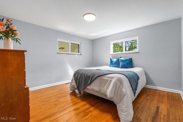 bedroom with baseboards and wood finished floors