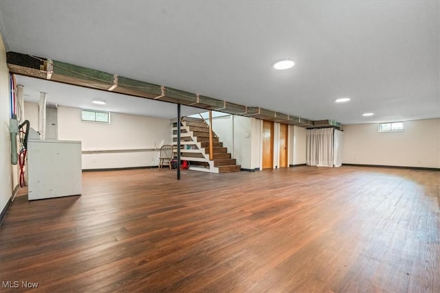 basement featuring stairs, recessed lighting, baseboards, and wood finished floors