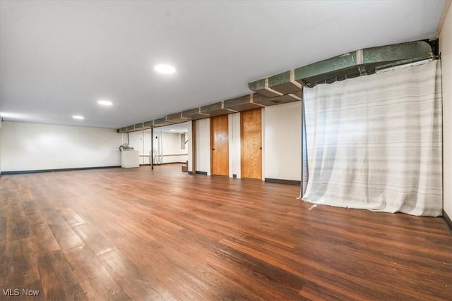 finished below grade area featuring recessed lighting, baseboards, and wood finished floors