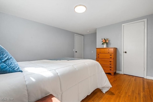 bedroom with baseboards and light wood-style flooring