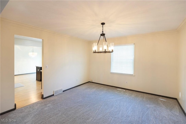 unfurnished room featuring crown molding, carpet, baseboards, and a notable chandelier