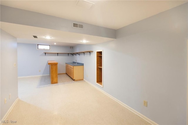 below grade area featuring baseboards and visible vents