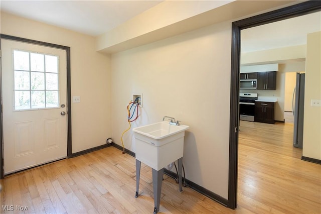 interior space featuring baseboards and light wood-style flooring