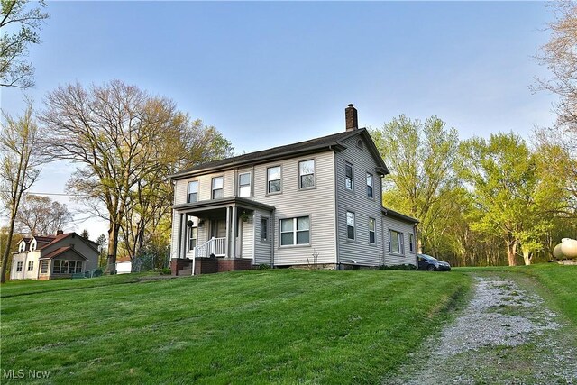 11680 Walnut Ave NE, Alliance, OH 44601 - view of front of property featuring covered porch, a chimney, and a front yard