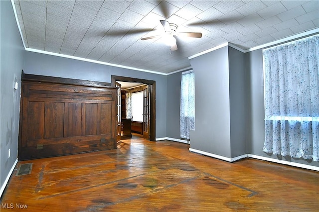 11680 Walnut Ave NE, Alliance, OH 44601 - empty room with baseboards, ornamental molding, dark wood-style floors, and visible vents