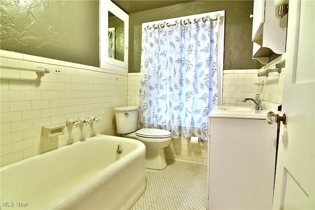 11680 Walnut Ave NE, Alliance, OH 44601 - bathroom with vanity, wainscoting, toilet, tile walls, and tile patterned floors