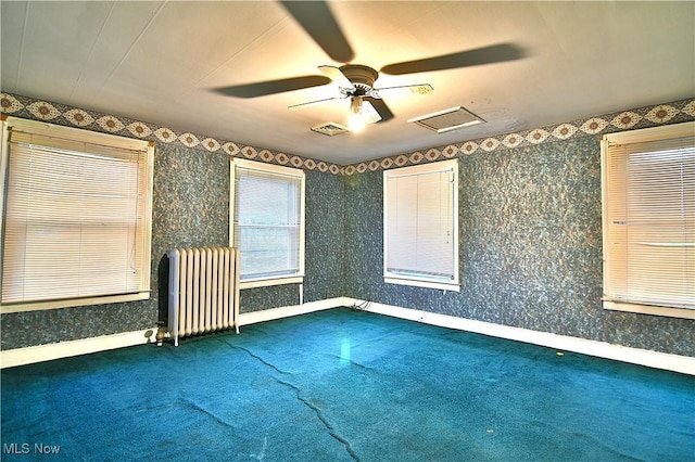 11680 Walnut Ave NE, Alliance, OH 44601 - carpeted empty room with a ceiling fan, attic access, visible vents, baseboards, and radiator