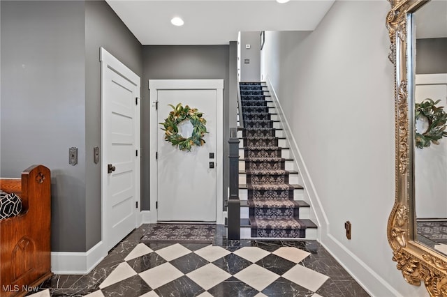foyer with stairway, baseboards, and recessed lighting