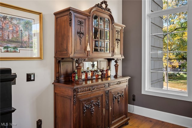 bar featuring baseboards and wood finished floors