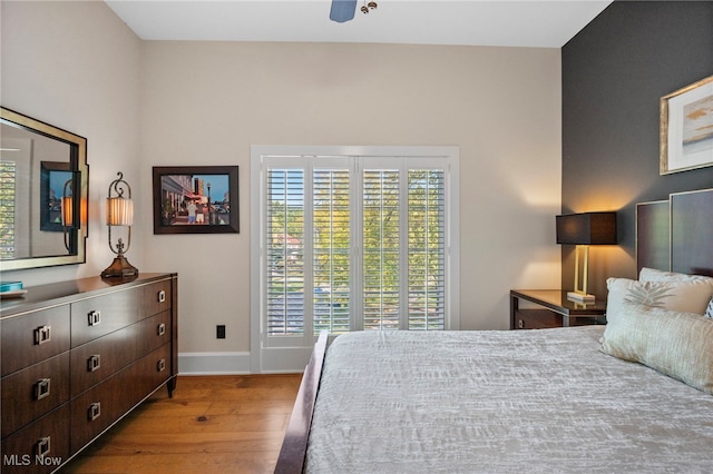 bedroom featuring baseboards, ceiling fan, and hardwood / wood-style flooring