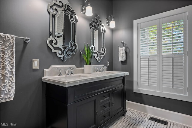 full bathroom featuring double vanity, tile patterned floors, visible vents, and a sink