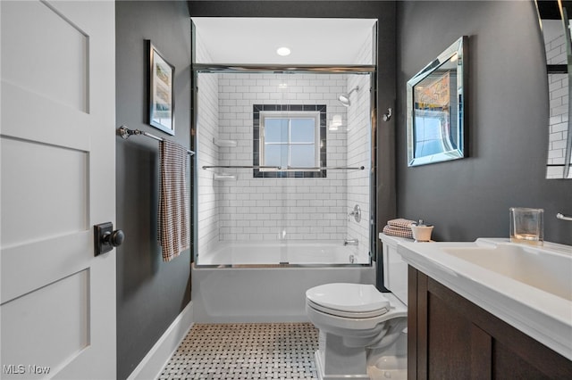 full bathroom with vanity, toilet, tile patterned floors, baseboards, and bath / shower combo with glass door
