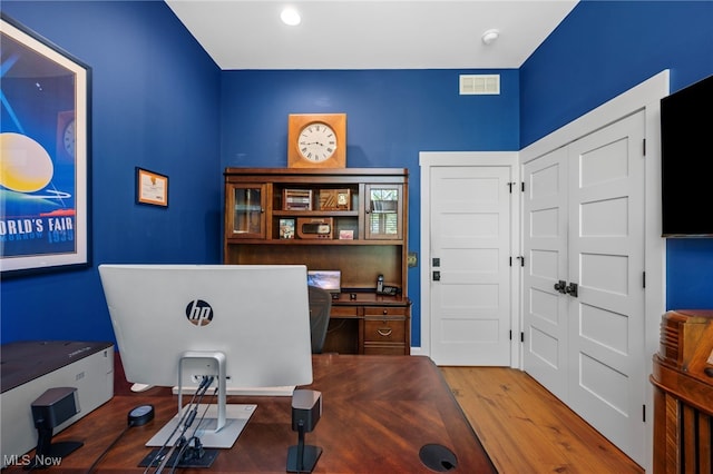 office space featuring visible vents and wood finished floors