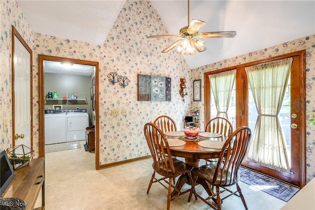 dining area featuring ceiling fan, vaulted ceiling, wallpapered walls, and independent washer and dryer