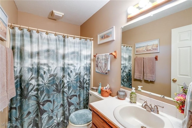 full bathroom with vanity, a shower with curtain, and toilet