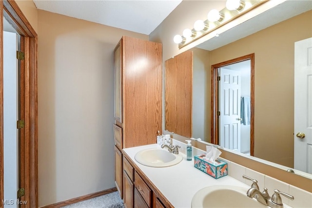 bathroom featuring double vanity and a sink