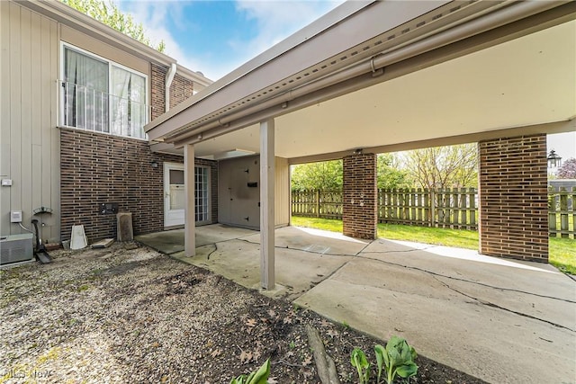 view of patio / terrace featuring fence and central AC unit