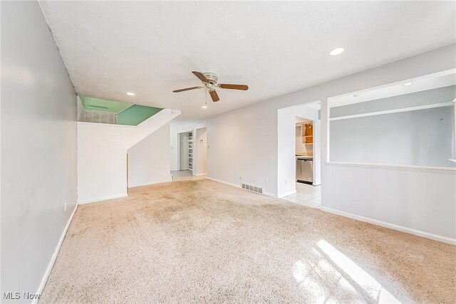 unfurnished living room with carpet floors, a ceiling fan, baseboards, recessed lighting, and visible vents