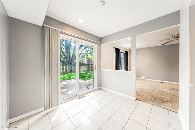 empty room with light colored carpet, recessed lighting, baseboards, light tile patterned floors, and visible vents