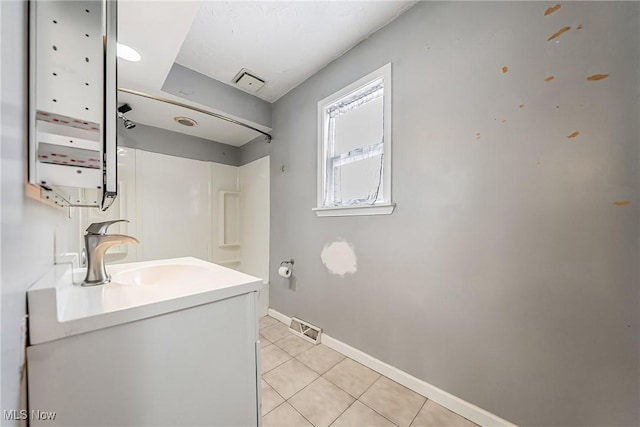 bathroom with walk in shower, tile patterned flooring, vanity, baseboards, and visible vents