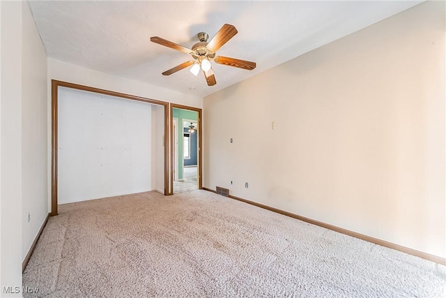 unfurnished bedroom featuring a closet, a ceiling fan, visible vents, and light carpet