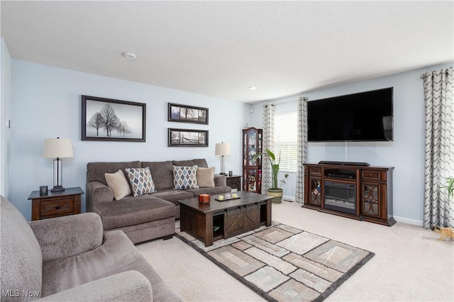 3939 Higgins Dr, Norton, OH 44203 - living room featuring baseboards, light carpet, and a fireplace