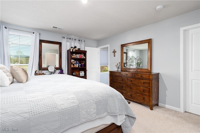 3939 Higgins Dr, Norton, OH 44203 - bedroom with baseboards, multiple windows, visible vents, and light colored carpet