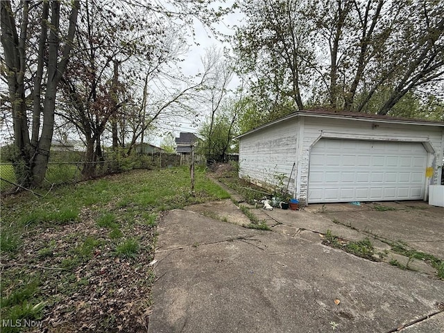 detached garage featuring fence