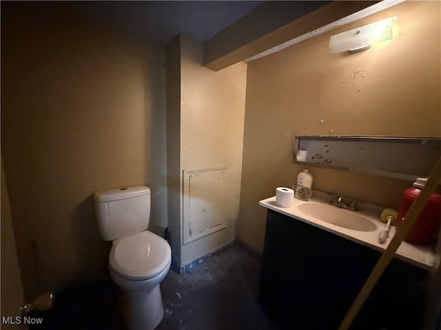 half bath featuring toilet, concrete flooring, and vanity