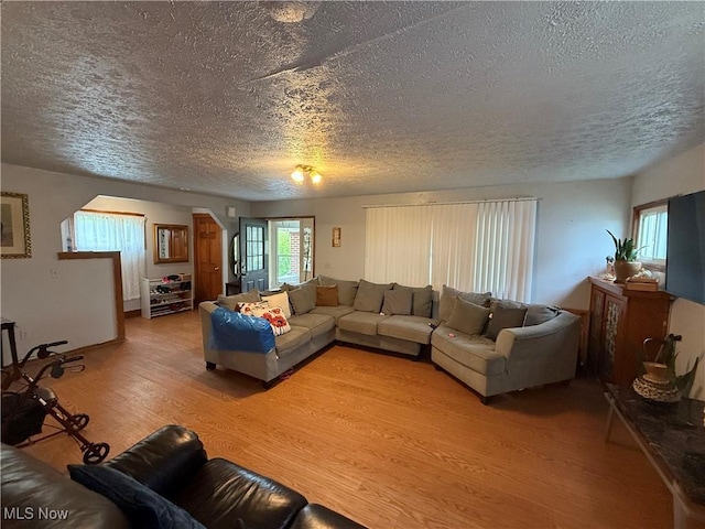 living area featuring a textured ceiling and light wood finished floors